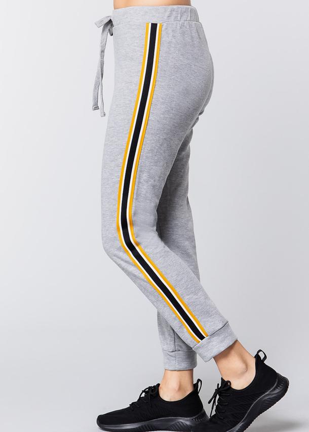 yellow joggers with black stripe